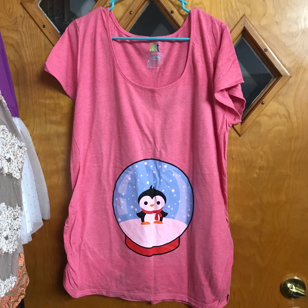 Pink maternity shirt with snow globe over belly